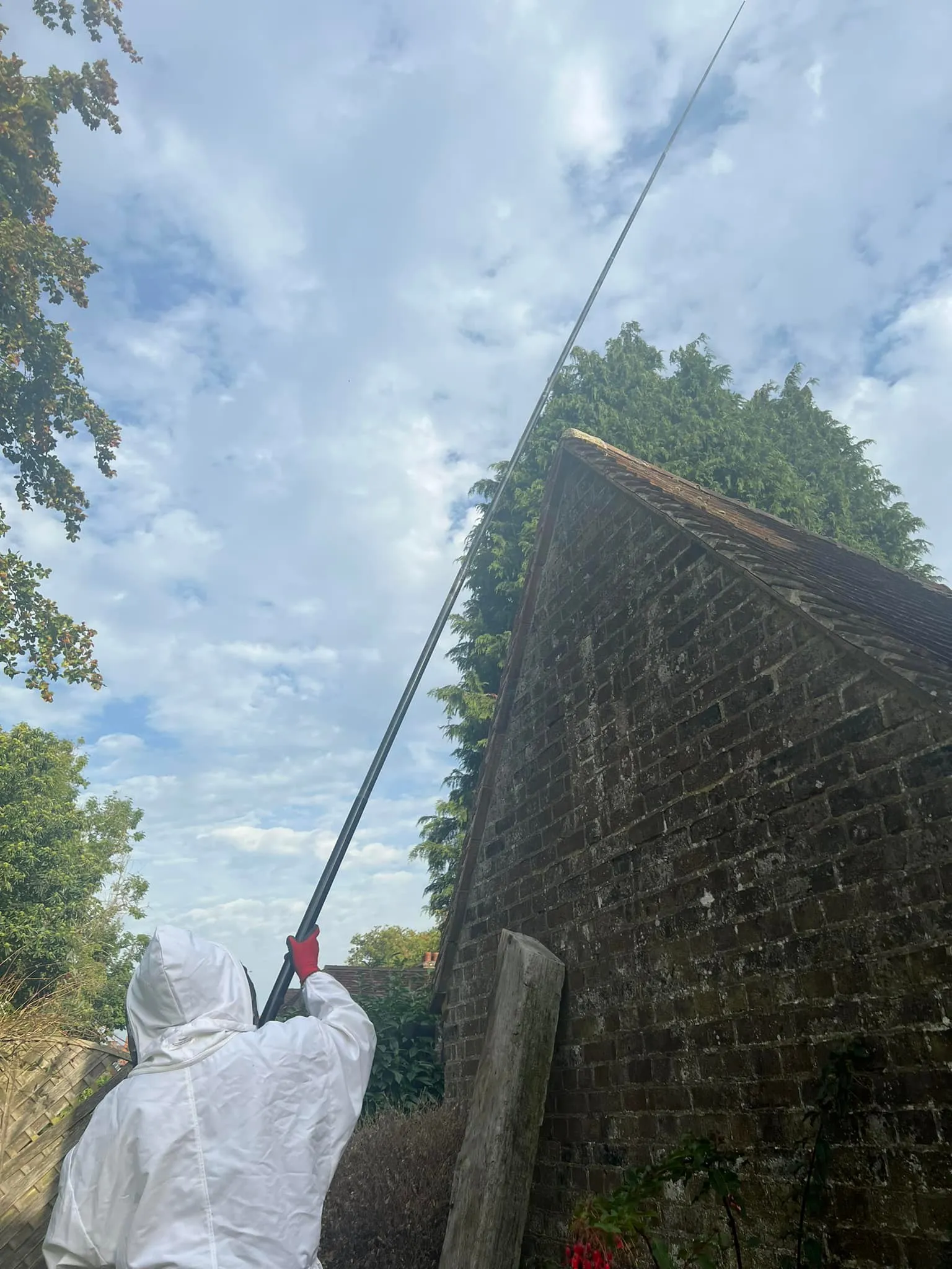 A person in a white jacket holding a fishing pole.