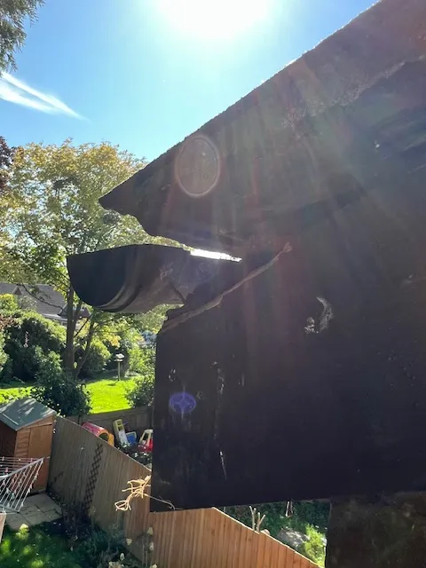 A large piece of metal sitting on top of a lush green field.